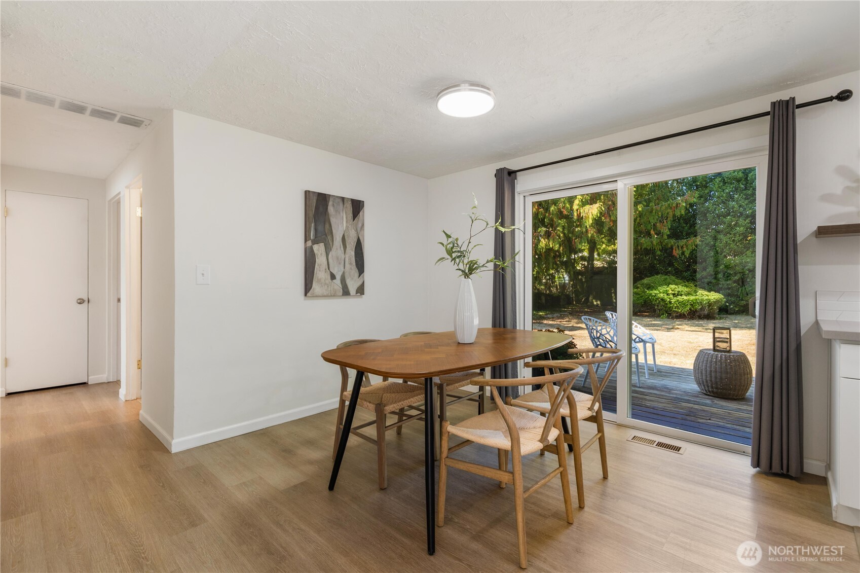 8423 198th Street Southwest Edmonds, WA 98026 - Photo 8 of 26 a view of a dining room with furniture and wooden floor