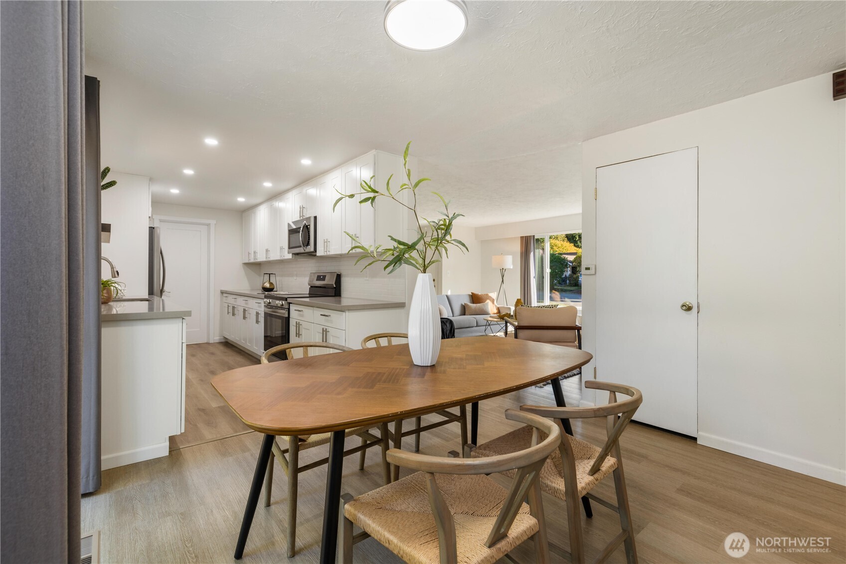 8423 198th Street Southwest Edmonds, WA 98026 - Photo 9 of 26 a view of a dining room with furniture and wooden floor