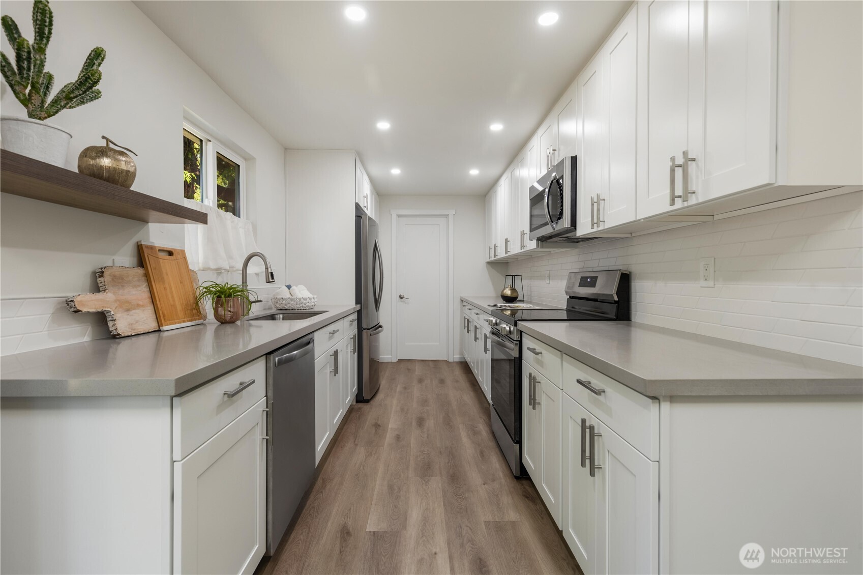 8423 198th Street Southwest Edmonds, WA 98026 - Photo 10 of 26 a large kitchen with stainless steel appliances granite countertop a lot of counter space and wooden floor
