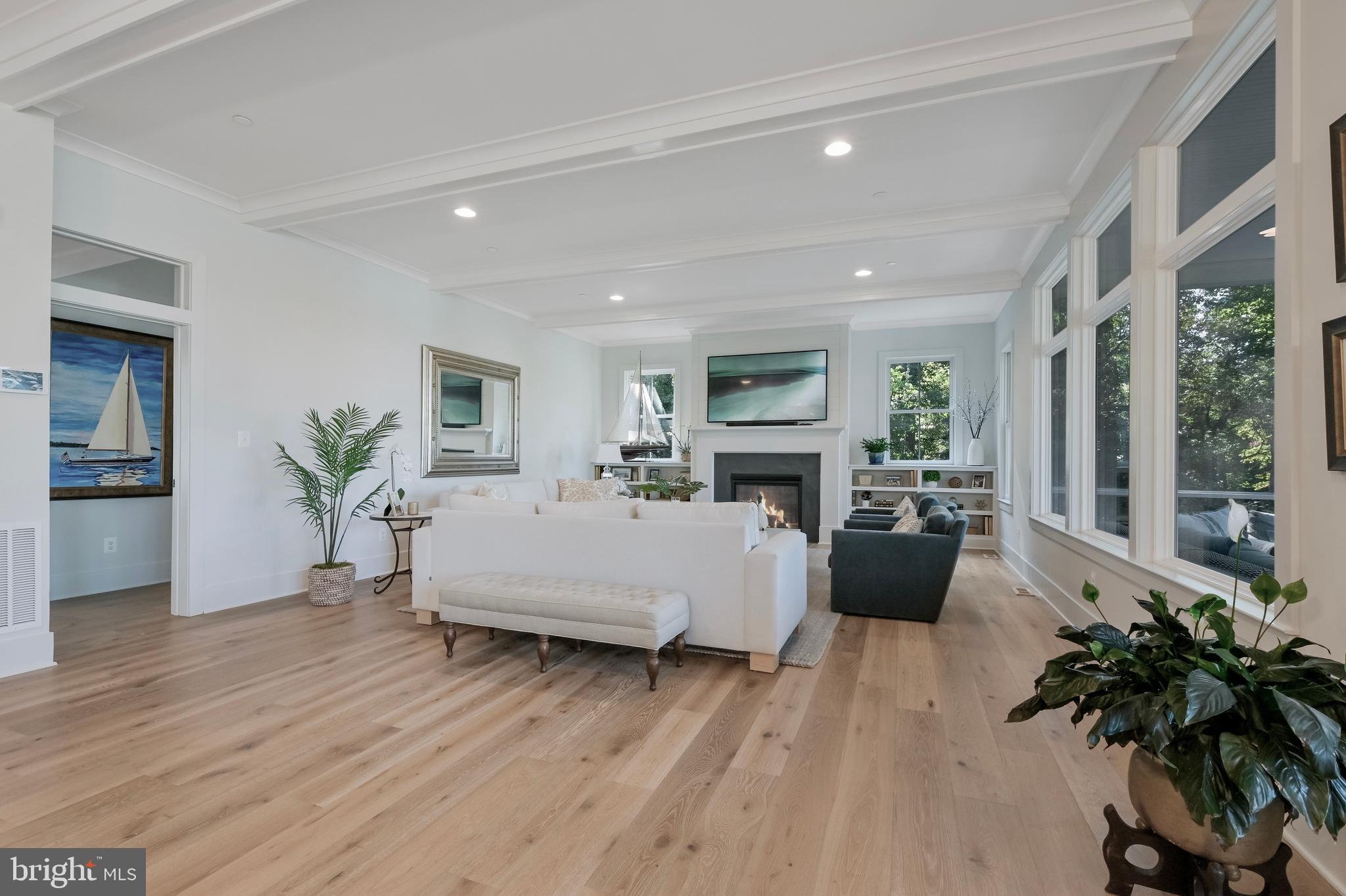 828 Swift Road Pasadena, MD 21122 - Photo 22 of 38 a living room with furniture large window and wooden floor