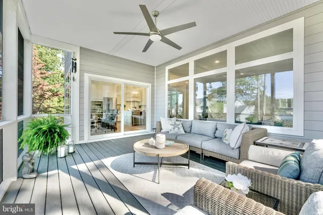 a living room with furniture a large window and a fireplace