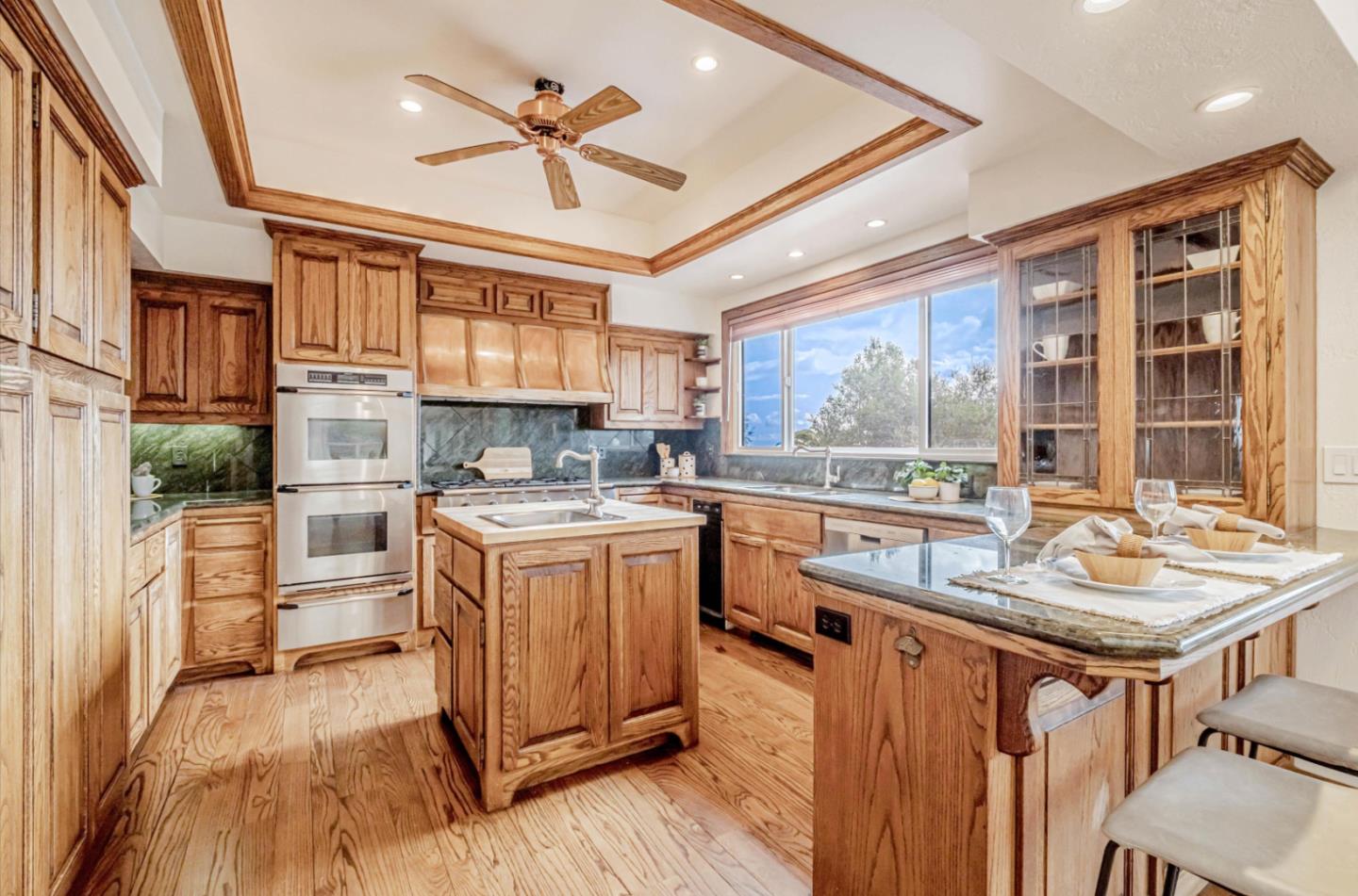 17070 Lon Road Los Gatos, CA 95033 - Photo 12 of 56 a kitchen with stainless steel appliances granite countertop a stove and a refrigerator