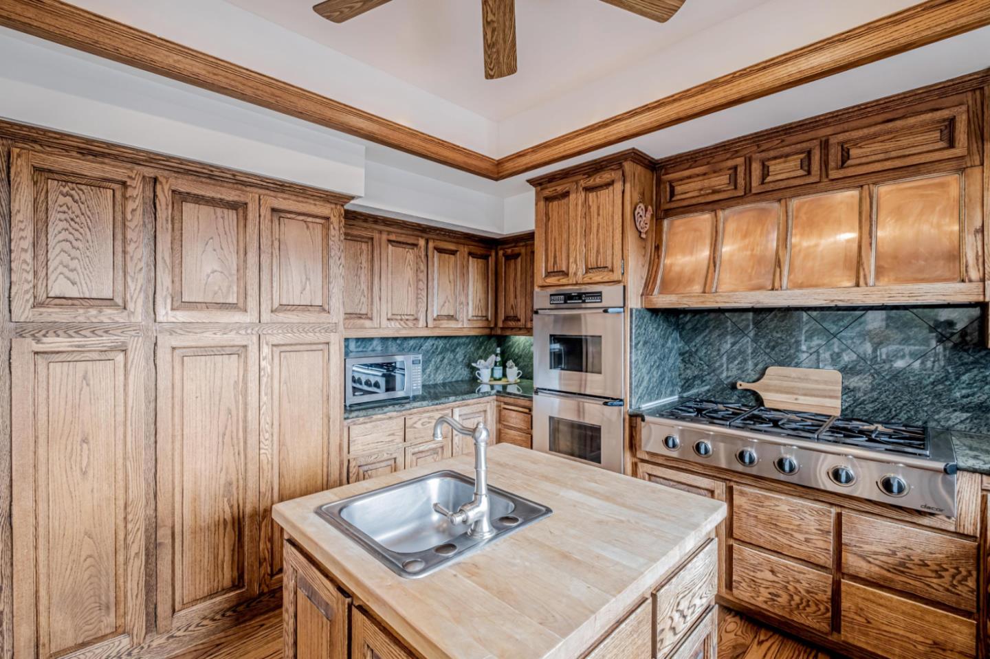 17070 Lon Road Los Gatos, CA 95033 - Photo 15 of 56 a kitchen with stainless steel appliances granite countertop a sink and cabinets