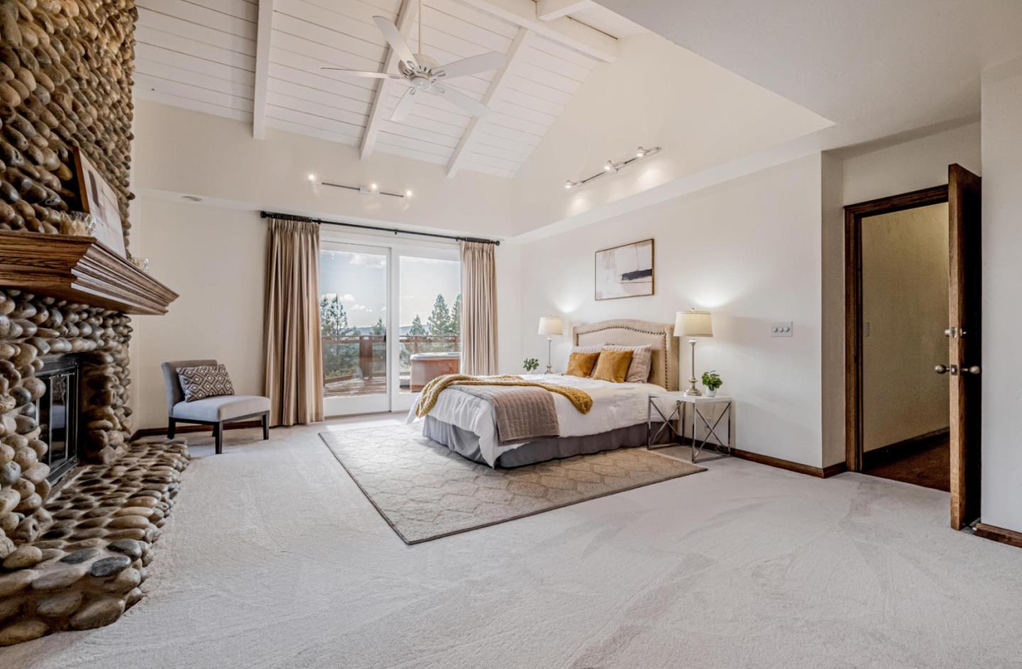 17070 Lon Road Los Gatos, CA 95033 - Photo 21 of 56 a bedroom with a large bed and a chandelier
