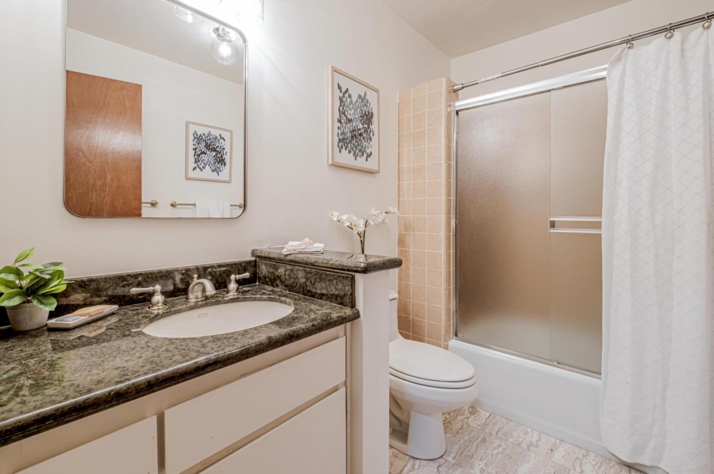 17070 Lon Road Los Gatos, CA 95033 - Photo 33 of 56 a bathroom with a granite countertop sink toilet and shower