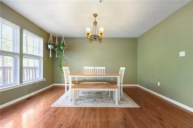 a view of empty room with a window and wooden floor