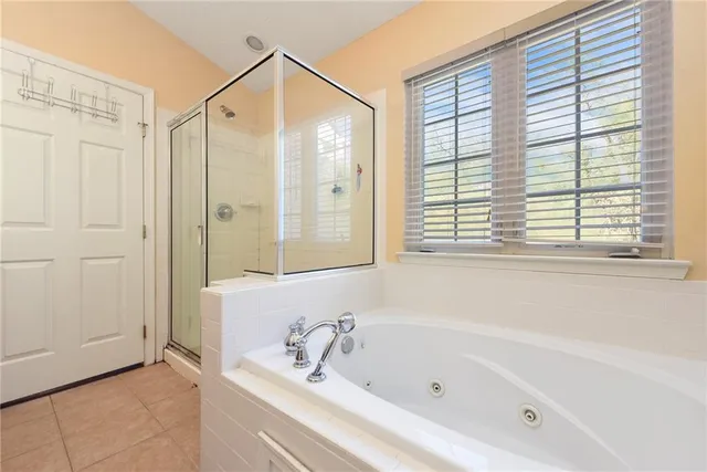 a bathroom with a bathtub and a shower