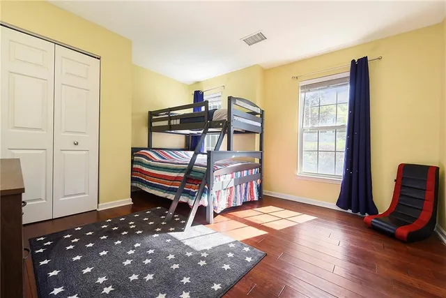 a bedroom with a bed and wooden floor