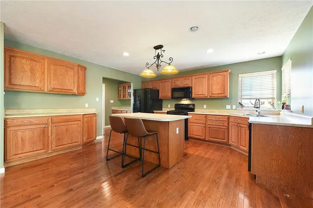 a kitchen with a sink appliances and cabinets