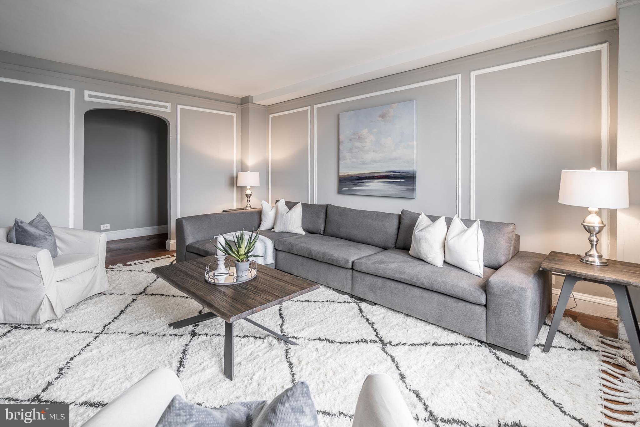 2031 Locust Street, Unit 602 Philadelphia, PA 19103 - Photo 2 of 24 a living room with furniture and a lamp
