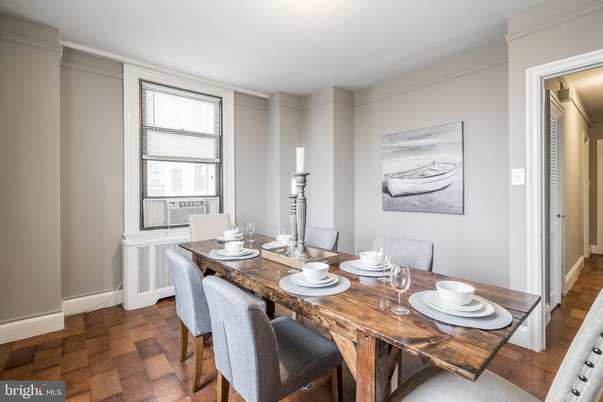 2031 Locust Street, Unit 602 Philadelphia, PA 19103 - Photo 4 of 24 a dining room with furniture and wooden floor