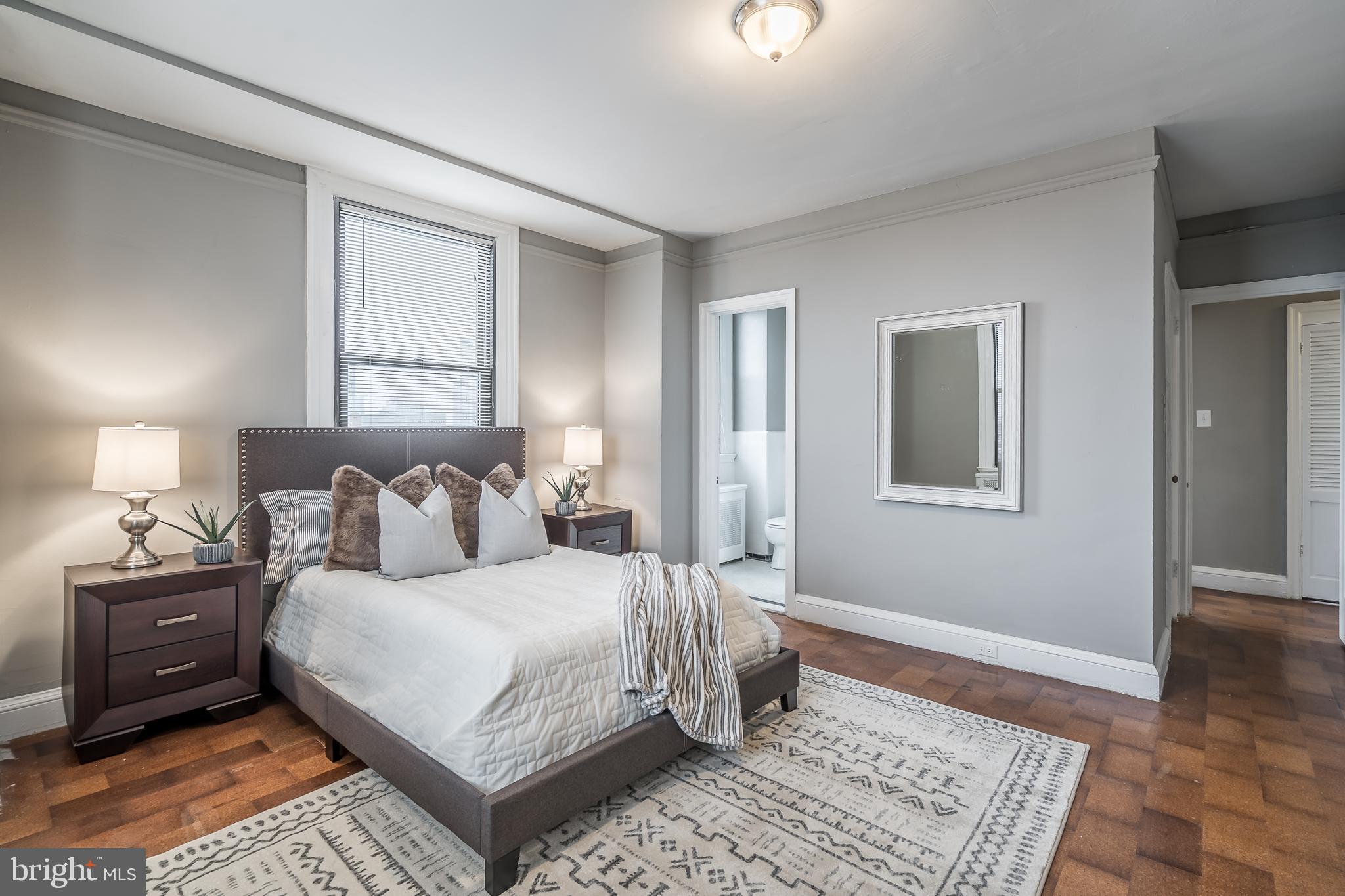 2031 Locust Street, Unit 602 Philadelphia, PA 19103 - Photo 9 of 24 a bedroom with a bed and wooden floor