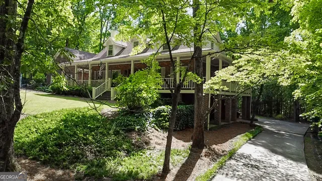 a view of house with yard and green space