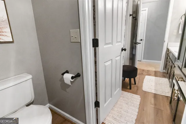 a view of a hallway with a livingroom and stairs