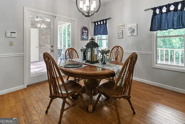 a very nice looking living room with wooden floor and a window