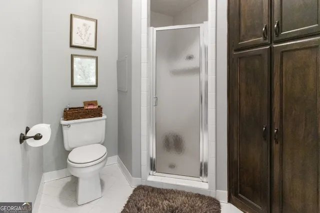 a bedroom with a bed and a mirror on dresser