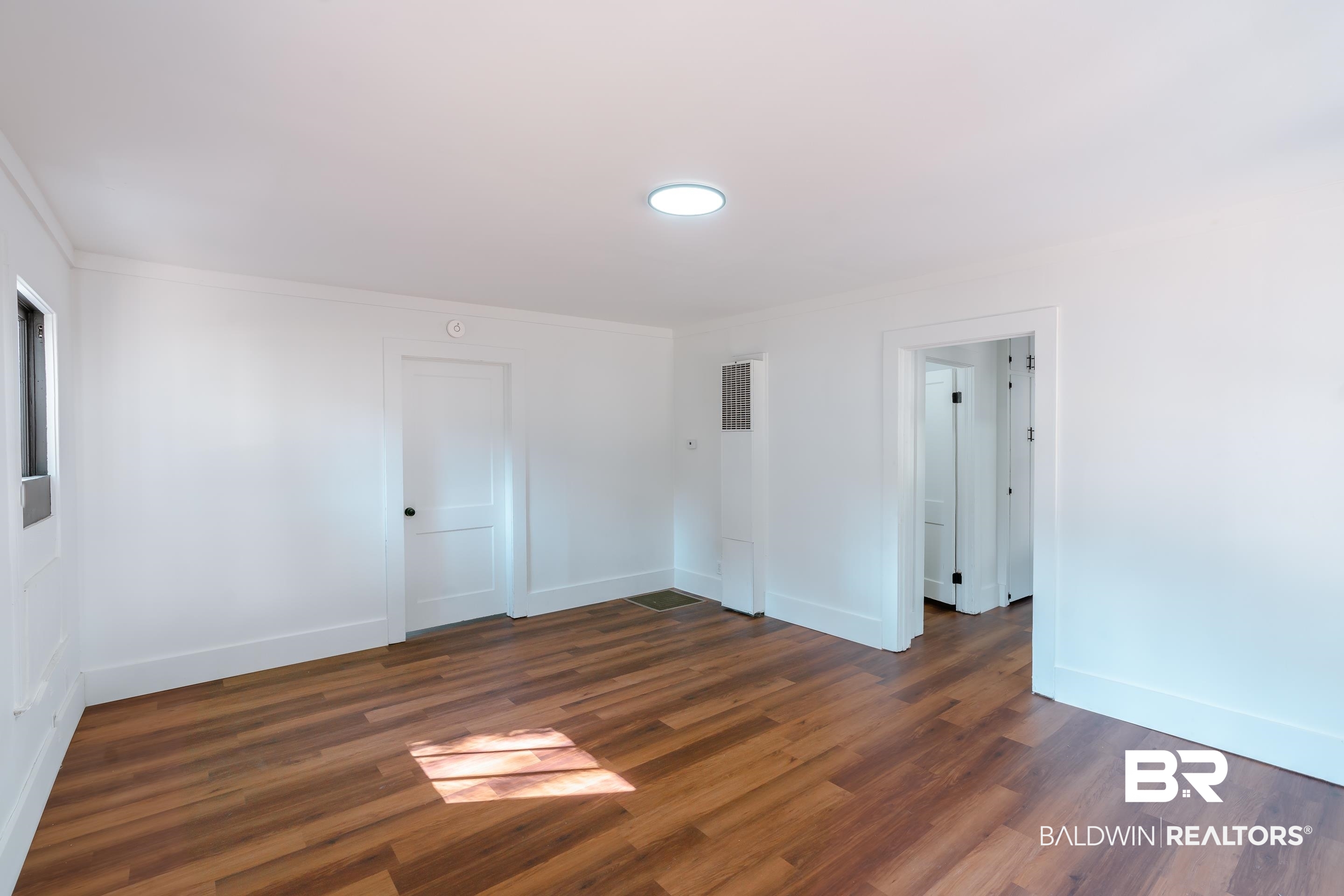 166 Crenshaw Street Mobile, AL 36606 - Photo 17 of 24 Empty room with crown molding and dark hardwood / wood-style floors