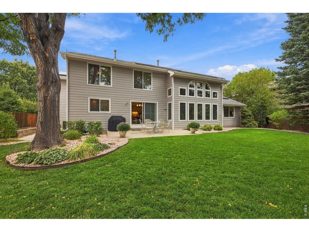 3754 Kentford Road Fort Collins, CO 80525 - Photo 42 of 50 Beautifully maintained backyard framed by mature trees & established landscaping