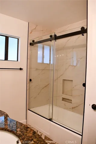 a bathroom with a glass shower door