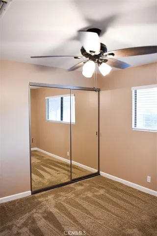 a view of a room with cabinet and ceiling fan