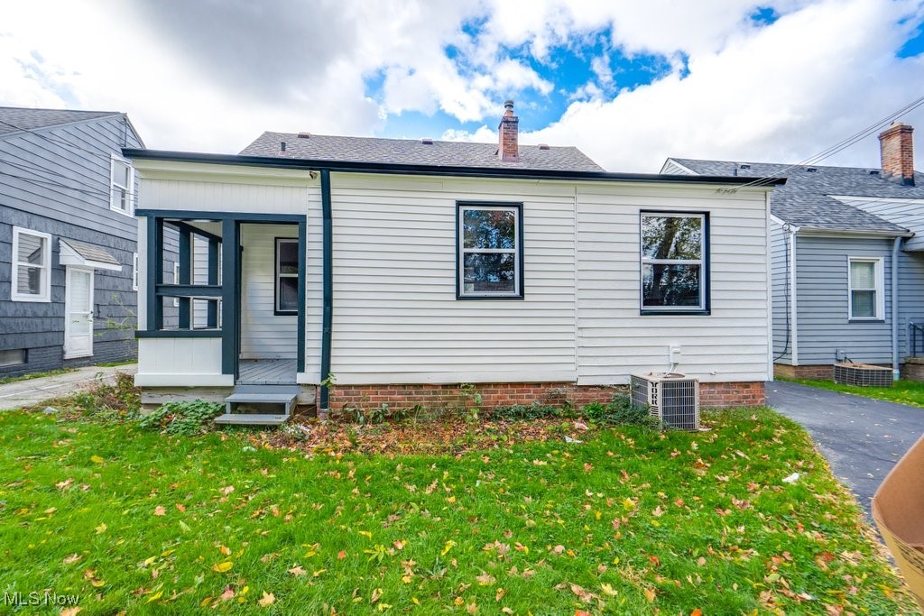 4237 Verona Road Cleveland, OH 44121 - Photo 6 of 41 Rear view of property with a lawn, a chimney, and a shingled roof
