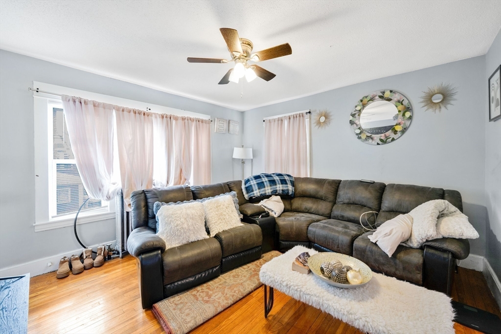 100-102 Wait Street Springfield, MA 01104 - Photo 17 of 35 a living room with furniture and a window