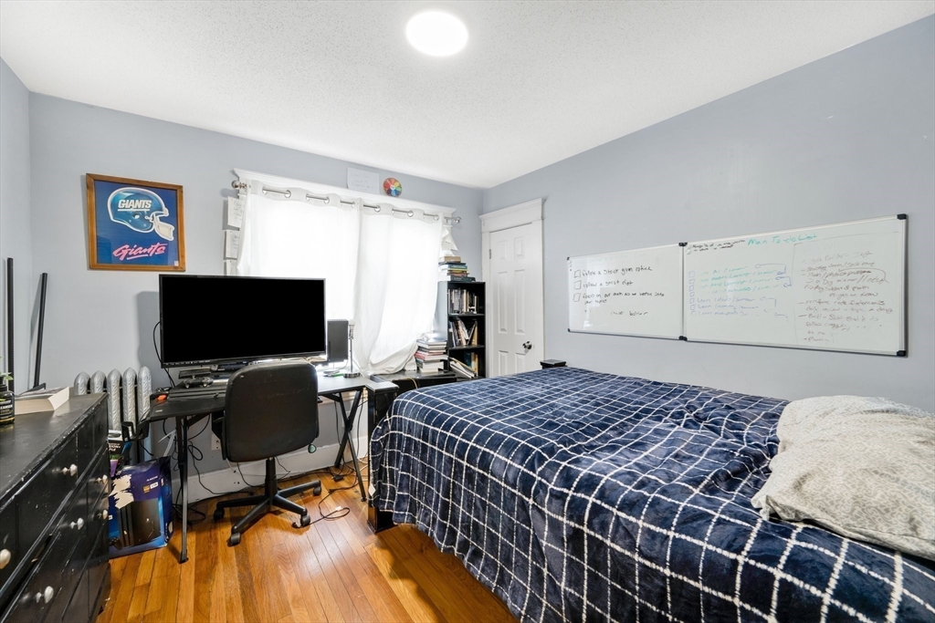 100-102 Wait Street Springfield, MA 01104 - Photo 20 of 35 a bedroom with a bed and a flat screen tv