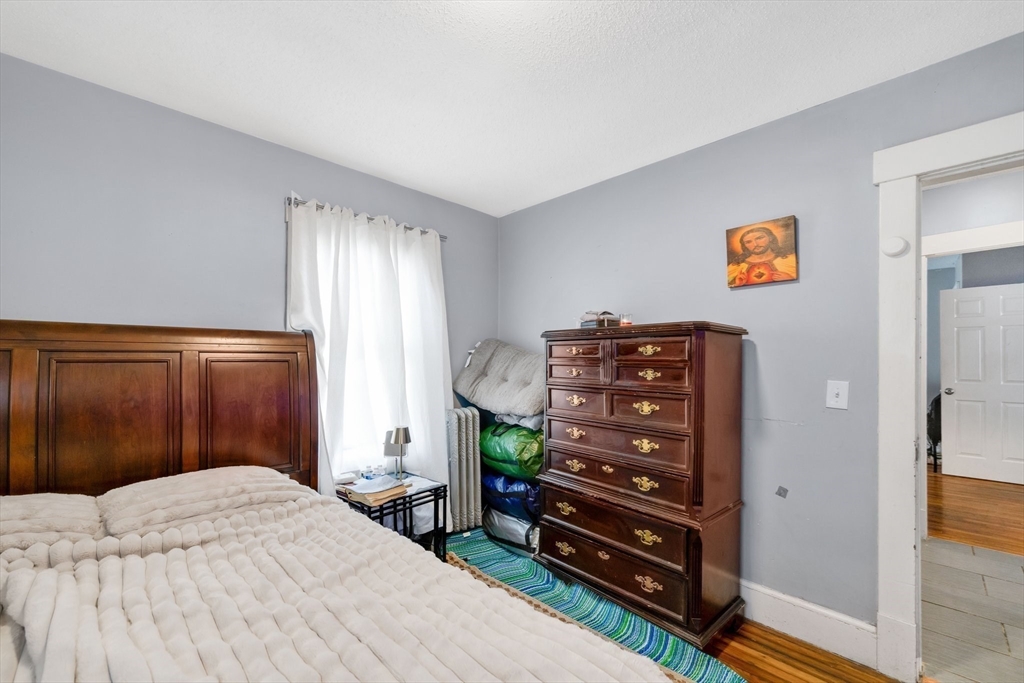 100-102 Wait Street Springfield, MA 01104 - Photo 23 of 35 a bedroom with a bed and a cabinets