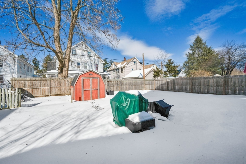 100-102 Wait Street Springfield, MA 01104 - Photo 35 of 35 a view of backyard with large trees and wooden fence