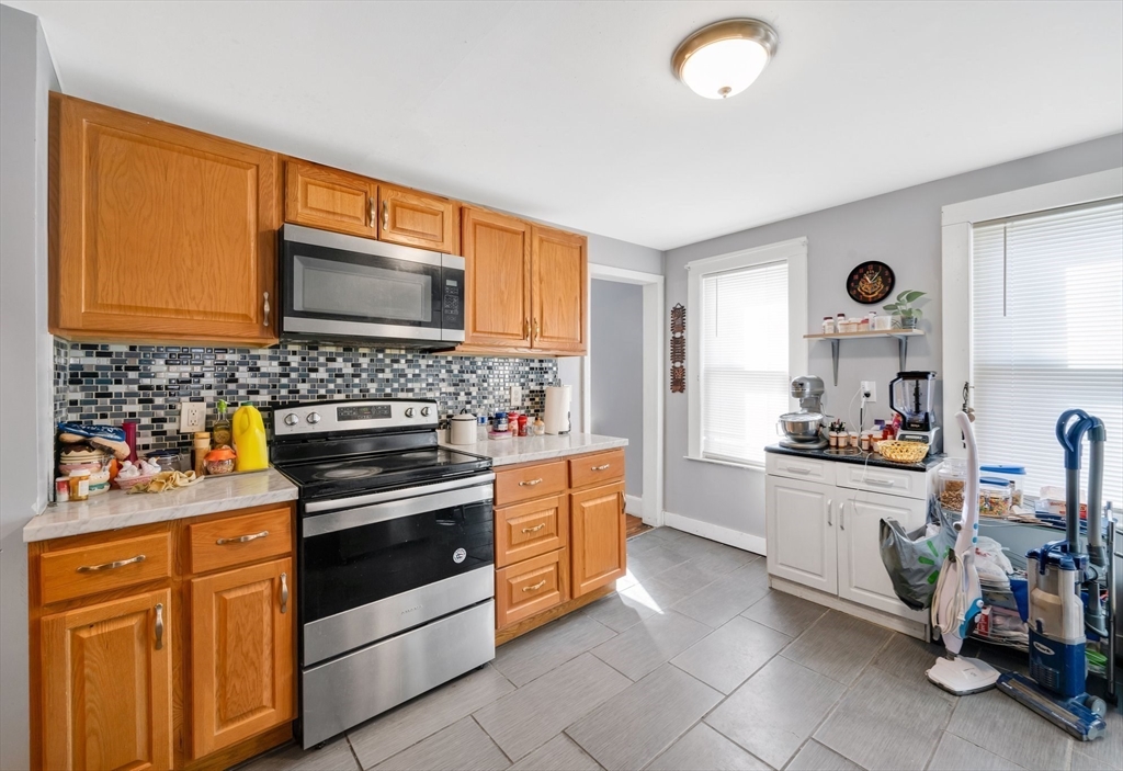 100-102 Wait Street Springfield, MA 01104 - Photo 7 of 35 a kitchen with stainless steel appliances a stove sink and microwave
