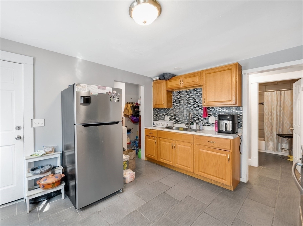 100-102 Wait Street Springfield, MA 01104 - Photo 8 of 35 a kitchen with refrigerator and cabinet