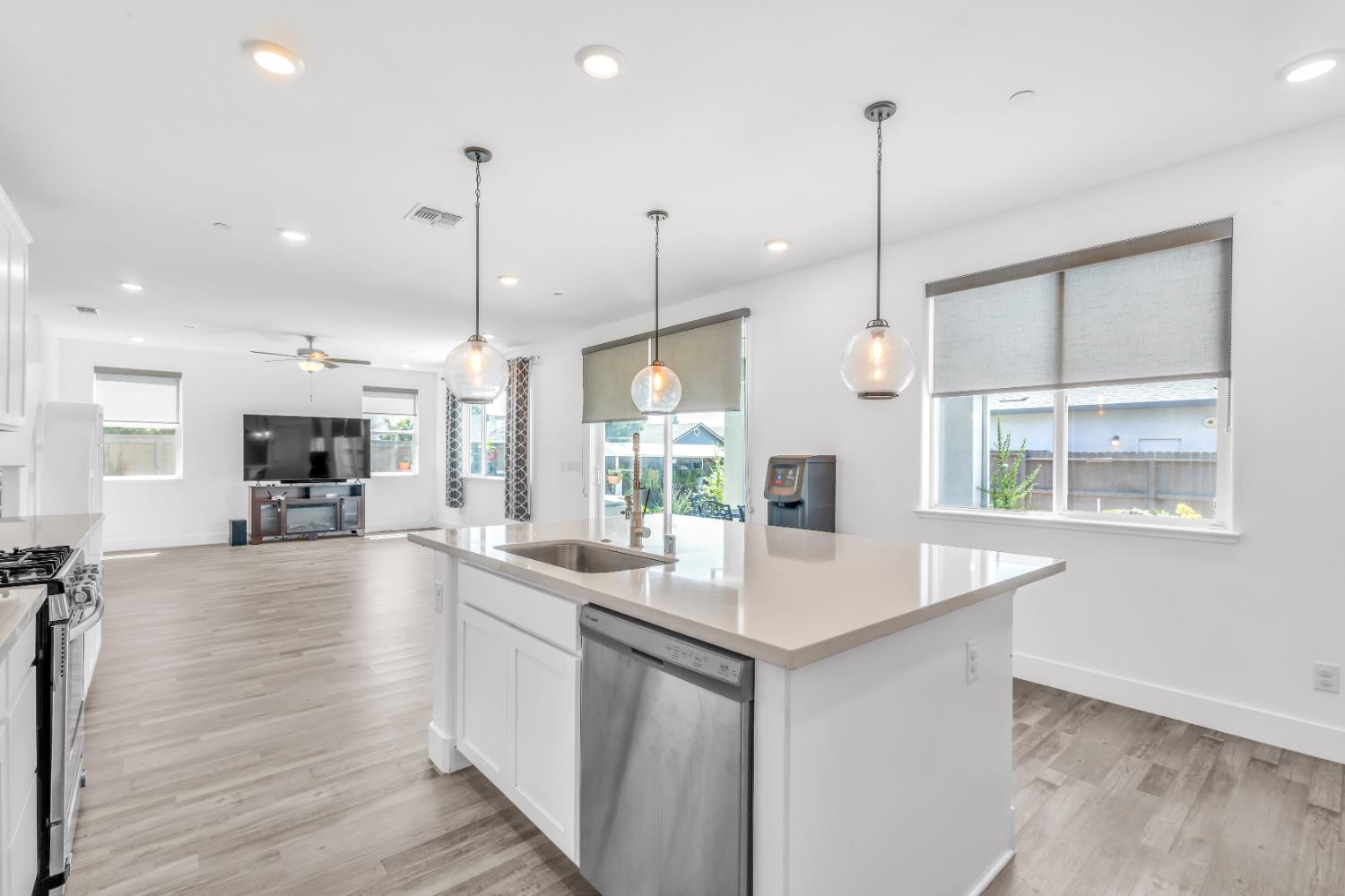 650 Nathaniel Avenue Galt, CA 95632 - Photo 14 of 46 a large kitchen with kitchen island a large island a sink stainless steel appliances and windows