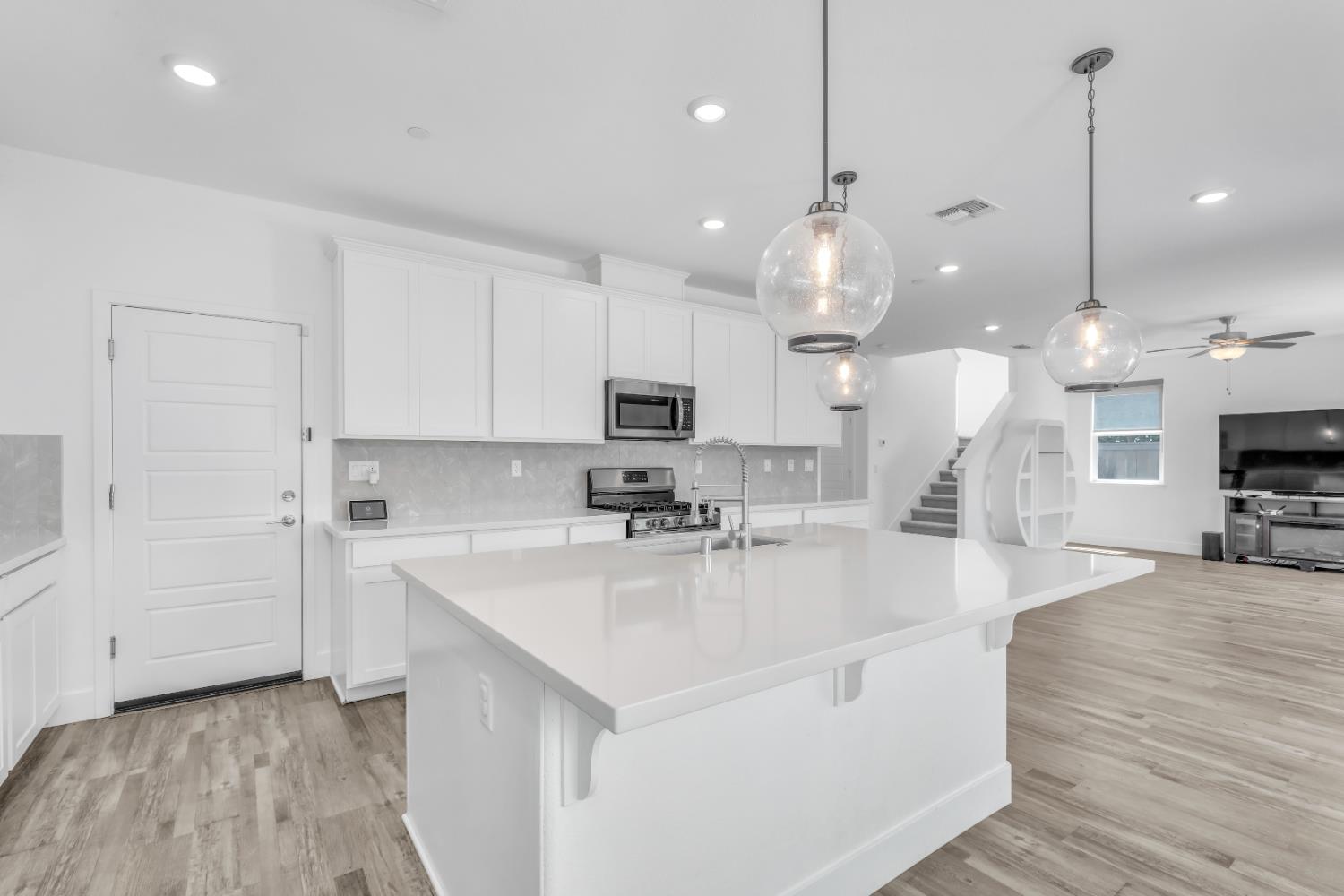 650 Nathaniel Avenue Galt, CA 95632 - Photo 15 of 46 a large kitchen with kitchen island a stove a sink a center island and wooden floor