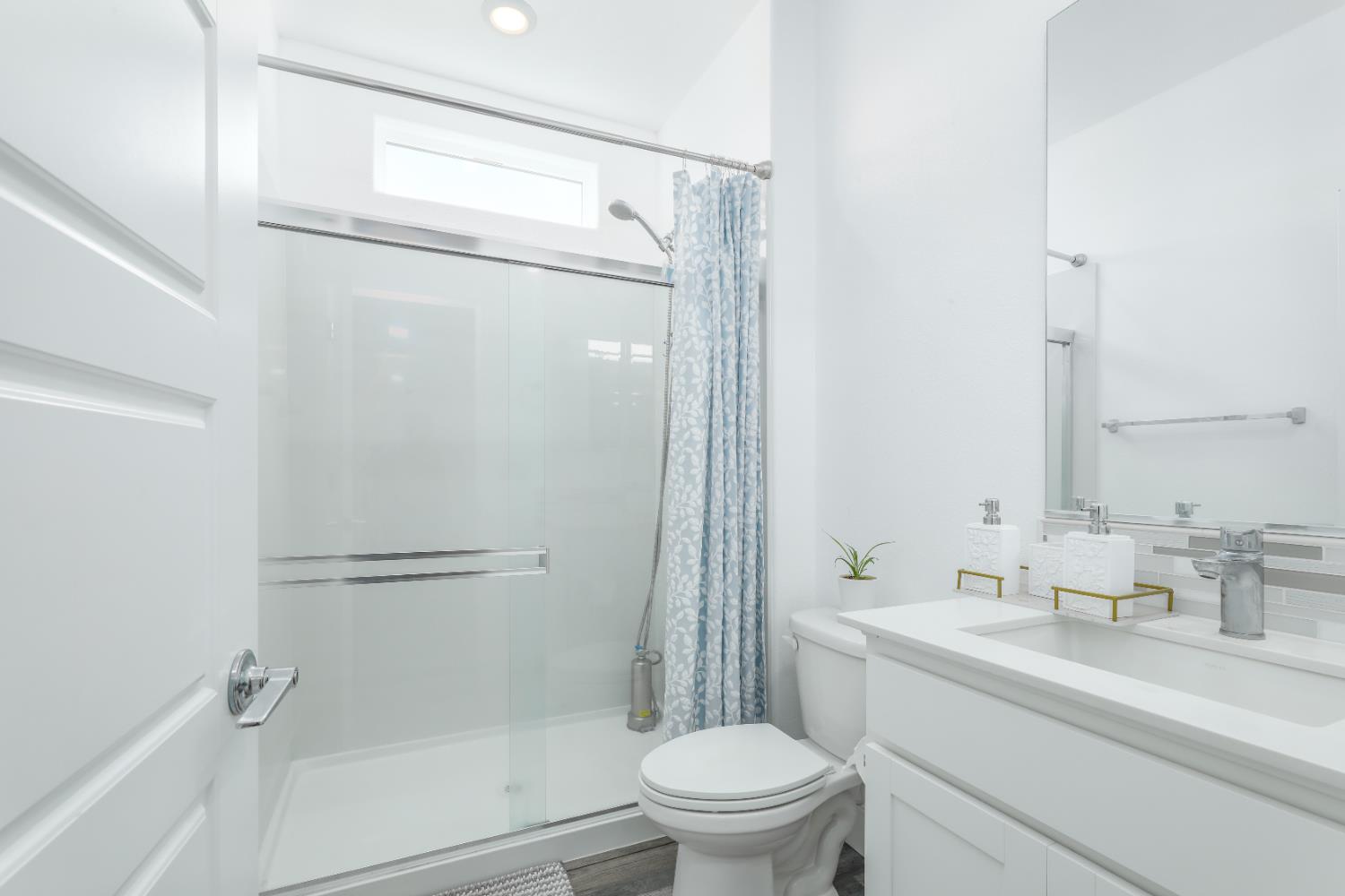 650 Nathaniel Avenue Galt, CA 95632 - Photo 19 of 46 a bathroom with a sink a mirror toilet and shower