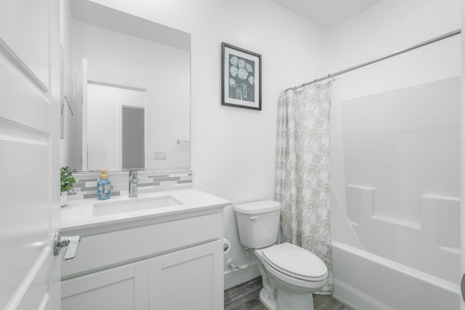 650 Nathaniel Avenue Galt, CA 95632 - Photo 28 of 46 a bathroom with a sink a toilet and a mirror