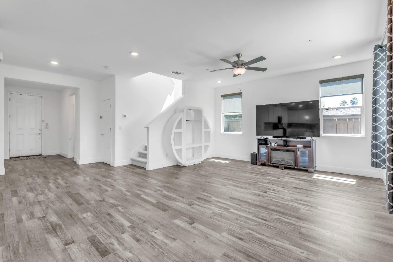 650 Nathaniel Avenue Galt, CA 95632 - Photo 7 of 46 a view of a livingroom with a flat screen tv wooden floor and a ceiling fan