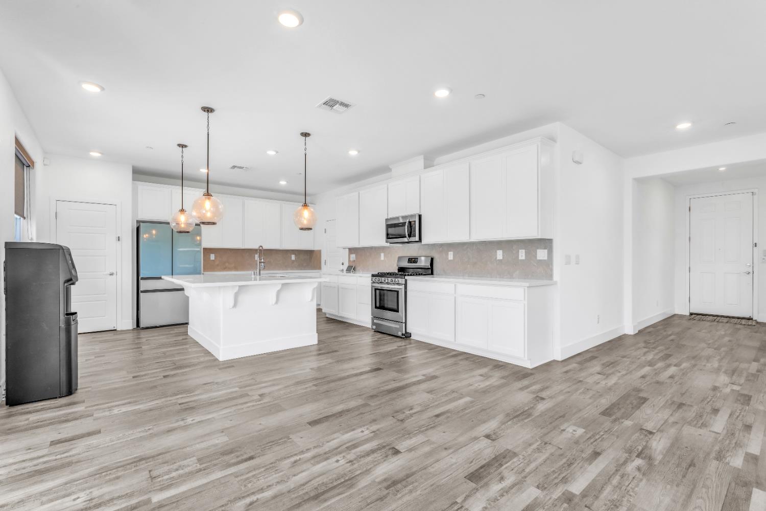 650 Nathaniel Avenue Galt, CA 95632 - Photo 10 of 46 a view of kitchen with kitchen island white cabinets stainless steel appliances and center island