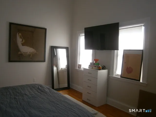 a kitchen with stainless steel appliances granite countertop a refrigerator sink and wooden floor
