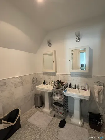 a bathroom with a sink toilet and a mirror