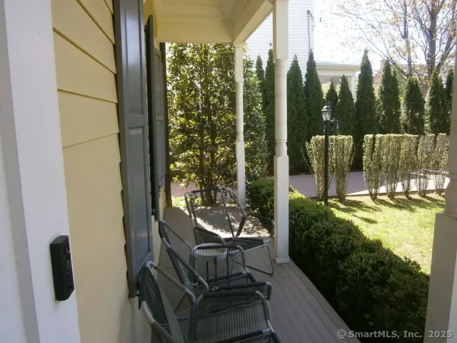 a view of a porch with chairs and backyard