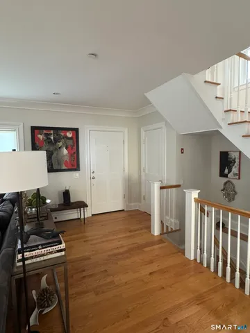 a living room with furniture a flat screen tv and a table