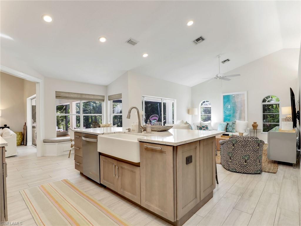 471 Ibis Way Naples, FL 34110 - Photo 20 of 40 a view of living room with granite countertop furniture and fireplace