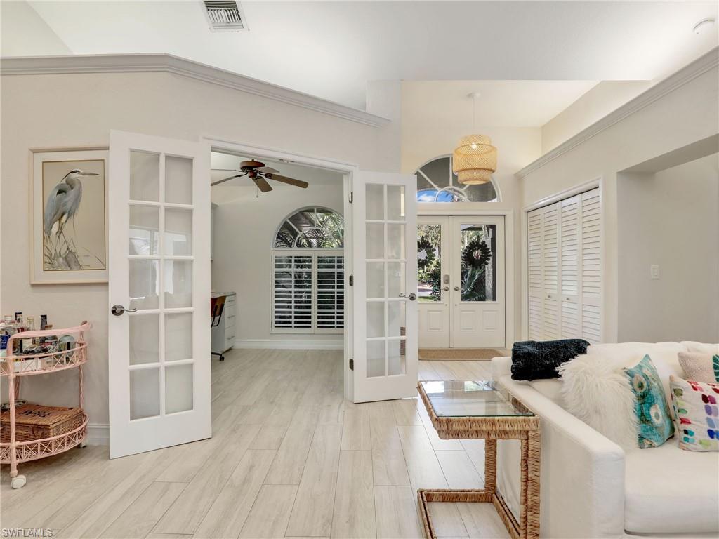 471 Ibis Way Naples, FL 34110 - Photo 2 of 40 a room with furniture a rug and a window