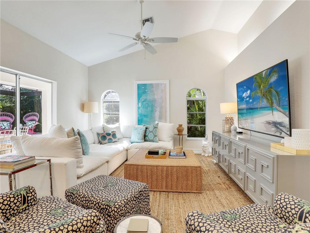 471 Ibis Way Naples, FL 34110 - Photo 22 of 40 a living room with furniture and a flat screen tv