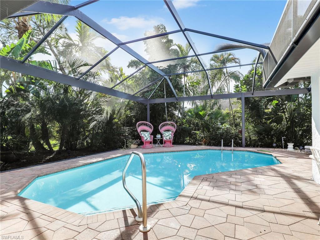 471 Ibis Way Naples, FL 34110 - Photo 23 of 40 a view of a swimming pool with a patio