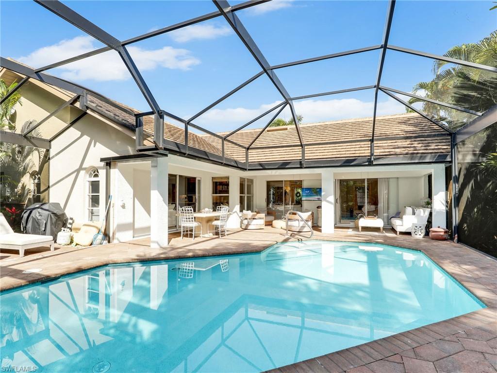 471 Ibis Way Naples, FL 34110 - Photo 25 of 40 a view of a swimming pool with a patio