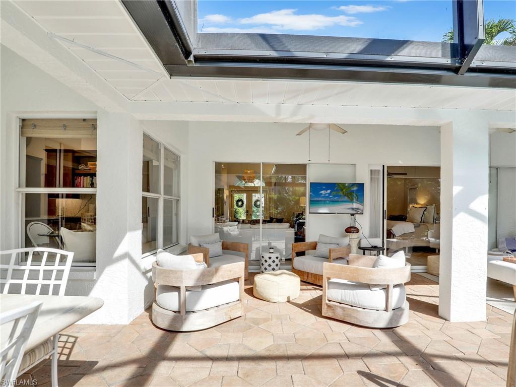 471 Ibis Way Naples, FL 34110 - Photo 28 of 40 a living room with furniture and a potted plant