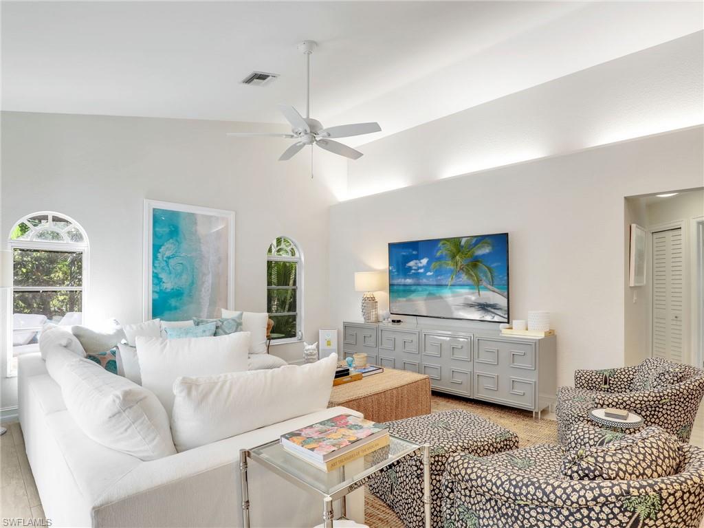 471 Ibis Way Naples, FL 34110 - Photo 29 of 40 a living room with furniture and a flat screen tv