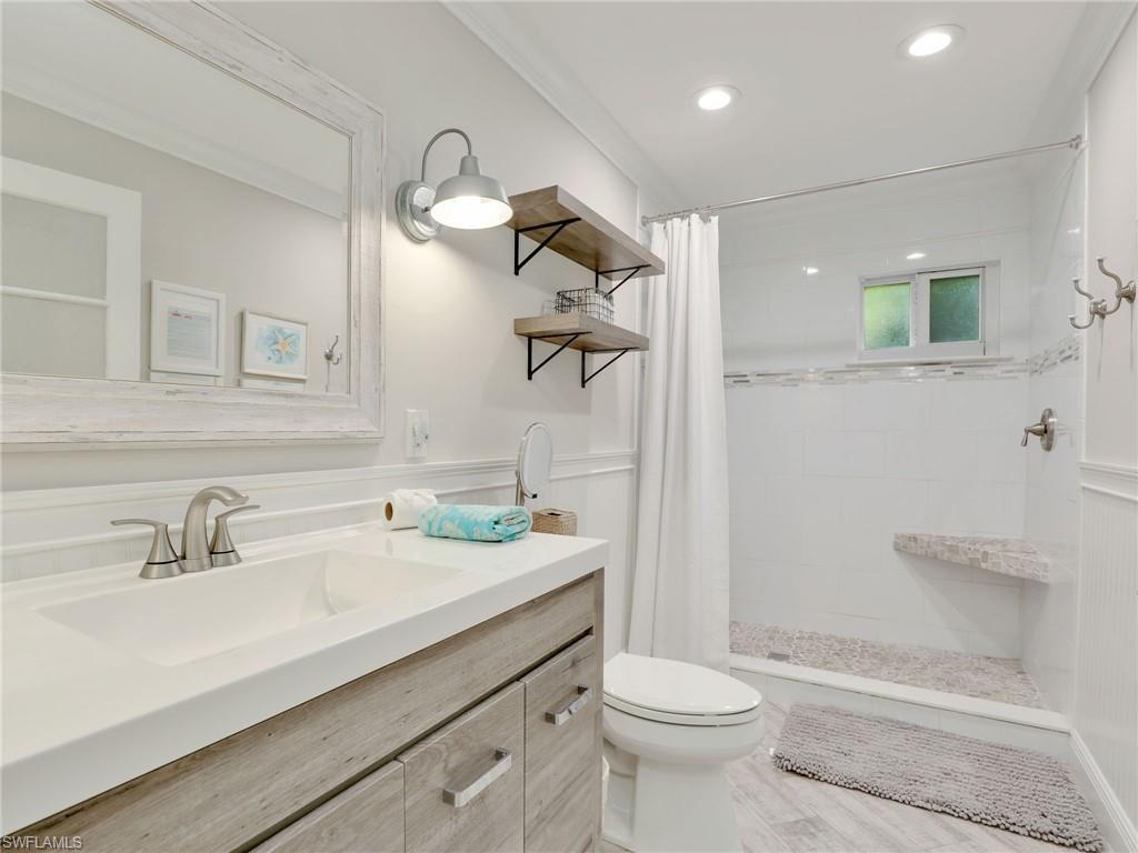 471 Ibis Way Naples, FL 34110 - Photo 31 of 40 a bathroom with a sink a toilet and shower