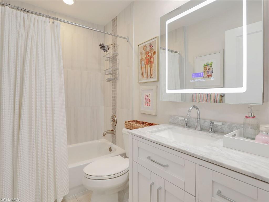 471 Ibis Way Naples, FL 34110 - Photo 34 of 40 a bathroom with a granite countertop sink a toilet and a shower